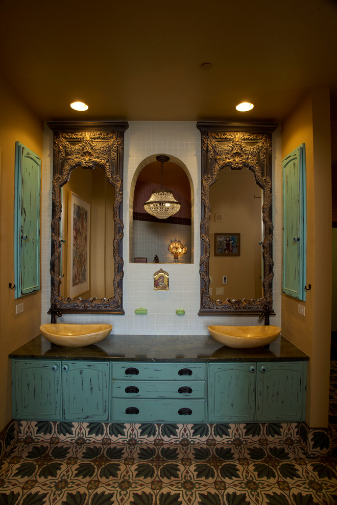 Design ideas for a medium sized eclectic ensuite bathroom in Milwaukee with a vessel sink, flat-panel cabinets, distressed cabinets, marble worktops, ceramic flooring, green tiles and yellow walls.