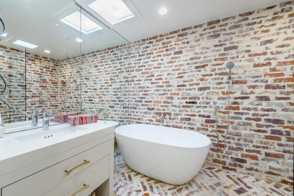 Exempel på ett litet modernt en-suite badrum, med släta luckor, vita skåp, ett fristående badkar, en dusch/badkar-kombination, en toalettstol med separat cisternkåpa, flerfärgad kakel, flerfärgade väggar, ljust trägolv, ett konsol handfat, marmorbänkskiva, beiget golv och med dusch som är öppen