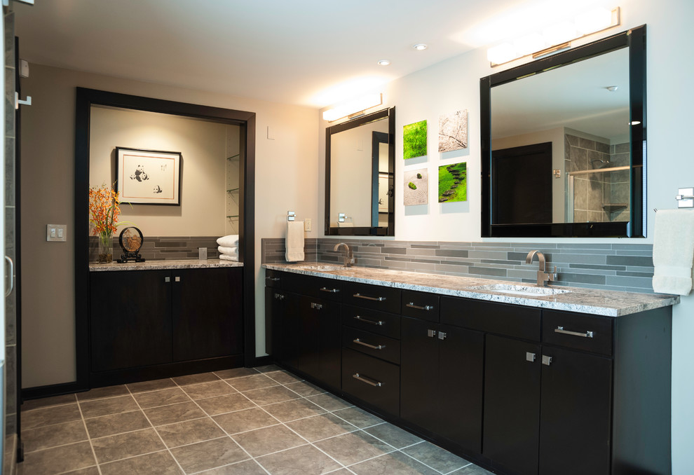 Large minimalist master brown tile and porcelain tile concrete floor and gray floor bathroom photo in Wichita with a vessel sink, flat-panel cabinets, dark wood cabinets, granite countertops and orange walls