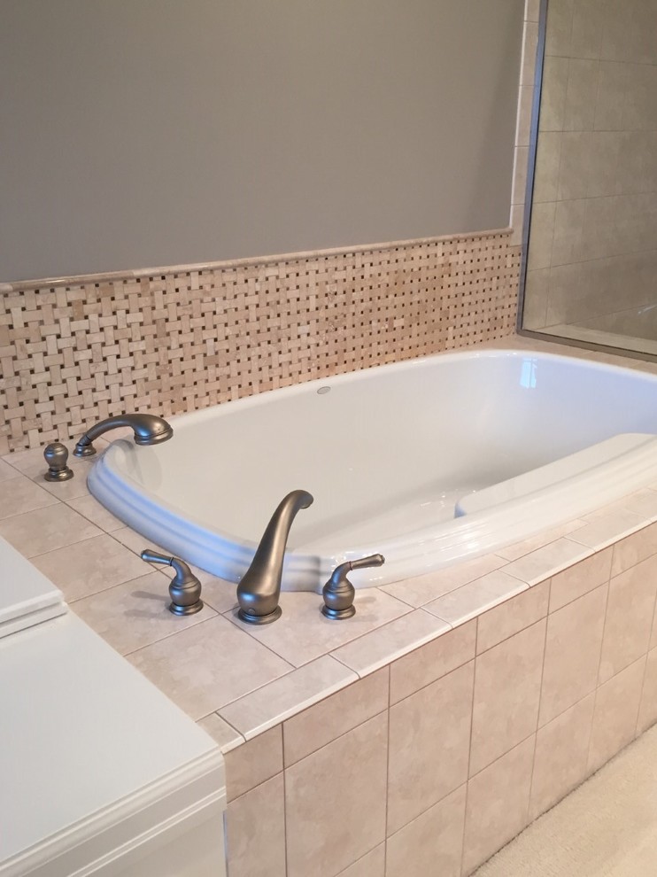 Photo of a traditional bathroom in Seattle with a built-in bath, beige tiles, ceramic tiles and grey walls.