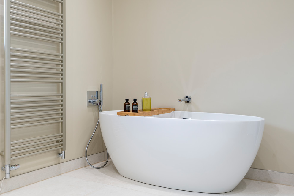 Inspiration for a medium sized contemporary family bathroom in West Midlands with white cabinets, a freestanding bath, a corner shower, a wall mounted toilet, beige walls, porcelain flooring, a vessel sink, quartz worktops, beige floors, a hinged door and beige worktops.