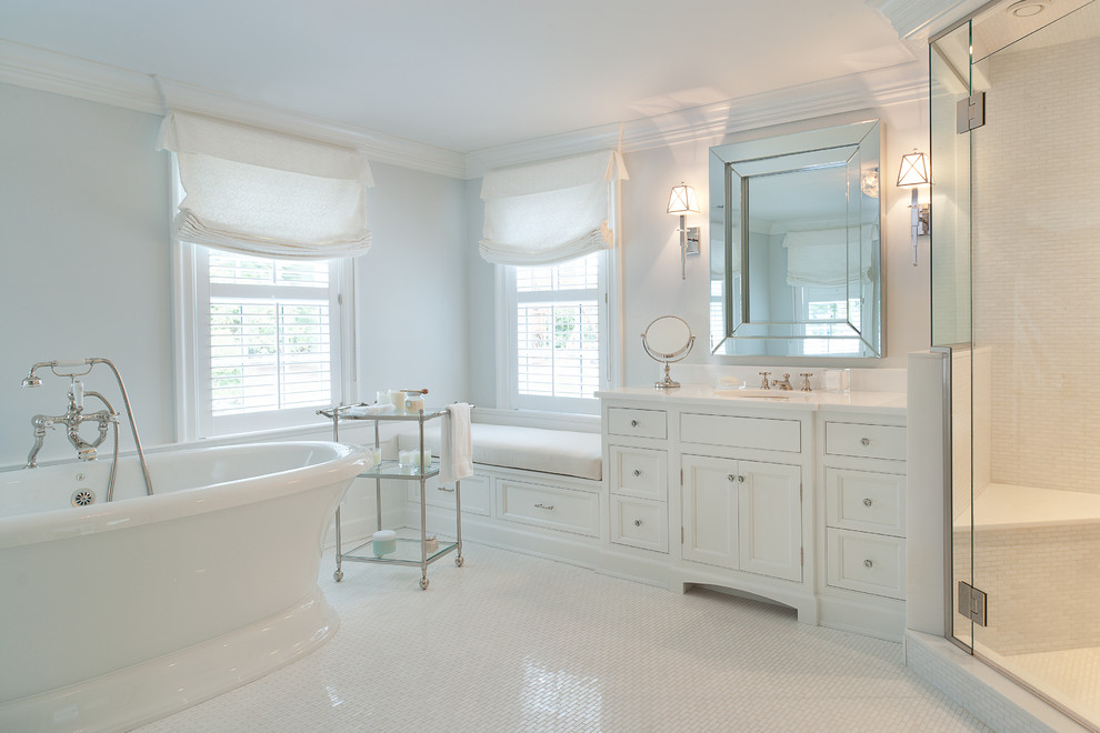 Пример оригинального дизайна: большая главная ванная комната в классическом стиле с фасадами с декоративным кантом, белыми фасадами, отдельно стоящей ванной, угловым душем, унитазом-моноблоком, белой плиткой, каменной плиткой, белыми стенами, мраморным полом, врезной раковиной и мраморной столешницей
