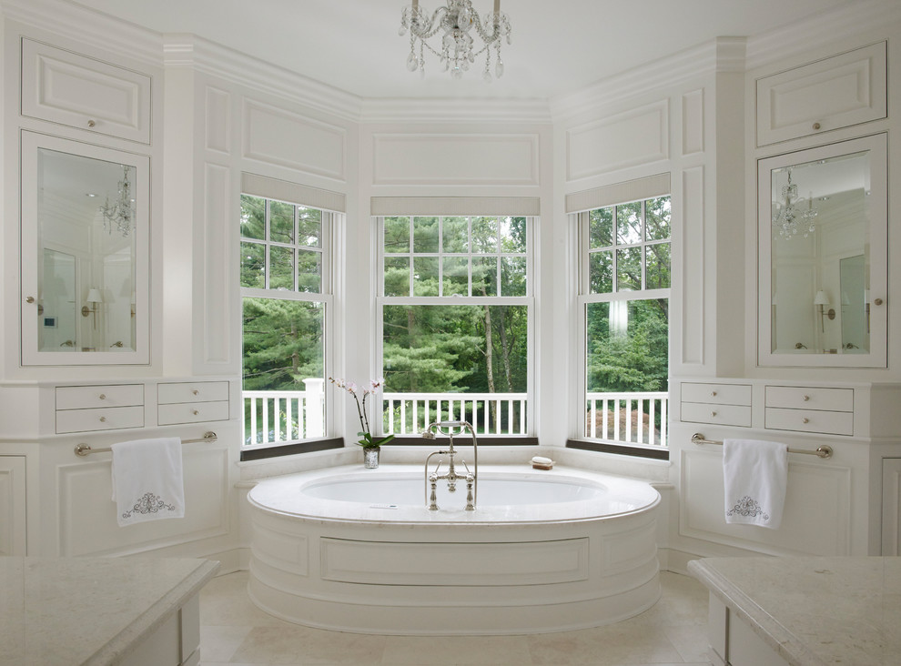 Immagine di una stanza da bagno con doccia chic con ante bianche, vasca sottopiano, pareti bianche e pavimento beige