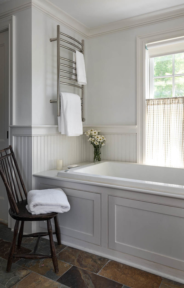 Photo of a medium sized farmhouse ensuite bathroom in Bridgeport with shaker cabinets, white cabinets, an alcove bath, white walls, slate flooring and brown floors.