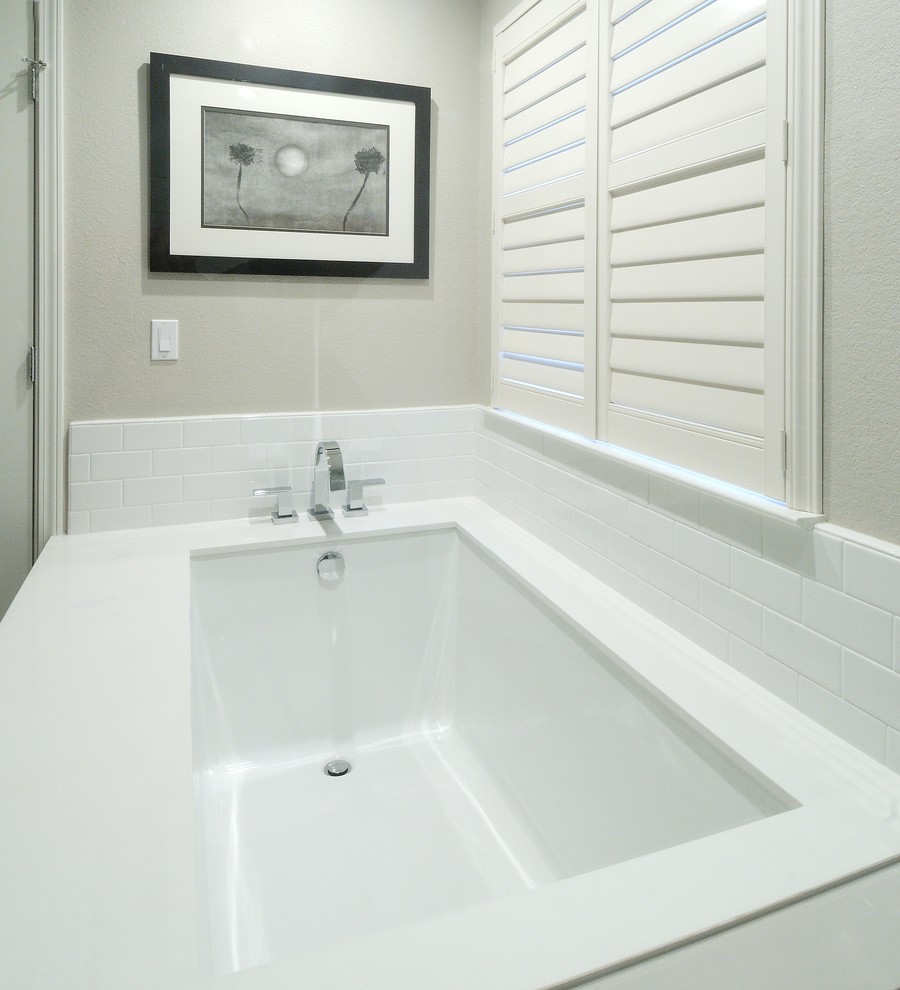 Inspiration for a mid-sized contemporary master white tile and subway tile porcelain tile corner shower remodel in Sacramento with an undermount sink, shaker cabinets, white cabinets, solid surface countertops, an undermount tub, a two-piece toilet and gray walls