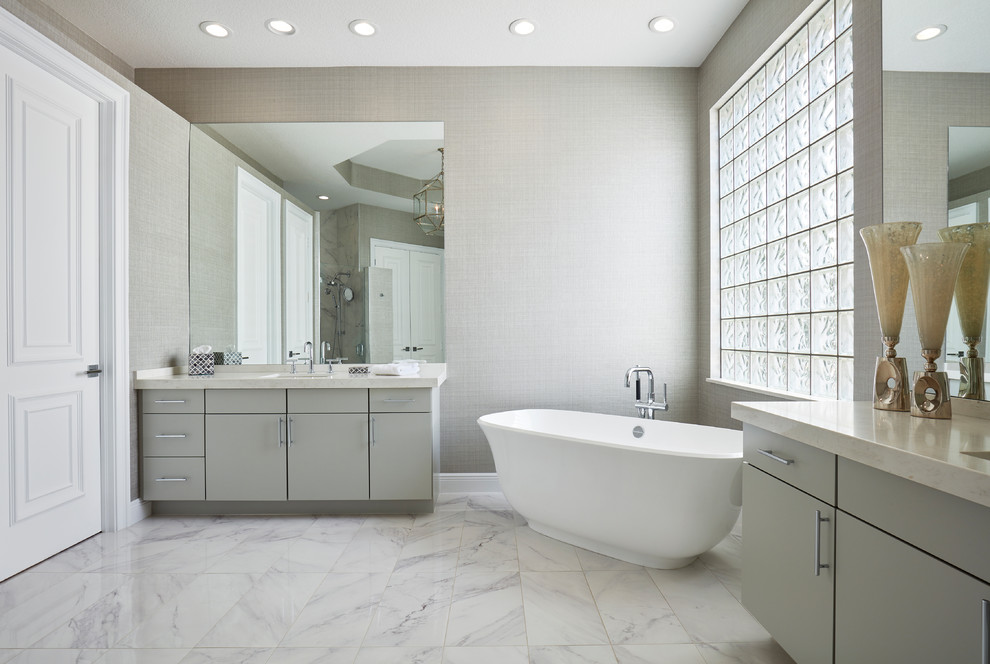 Design ideas for an expansive contemporary ensuite bathroom in Miami with flat-panel cabinets, grey cabinets, a freestanding bath, a walk-in shower, grey walls, marble flooring, an integrated sink, engineered stone worktops, grey floors, an open shower and white worktops.