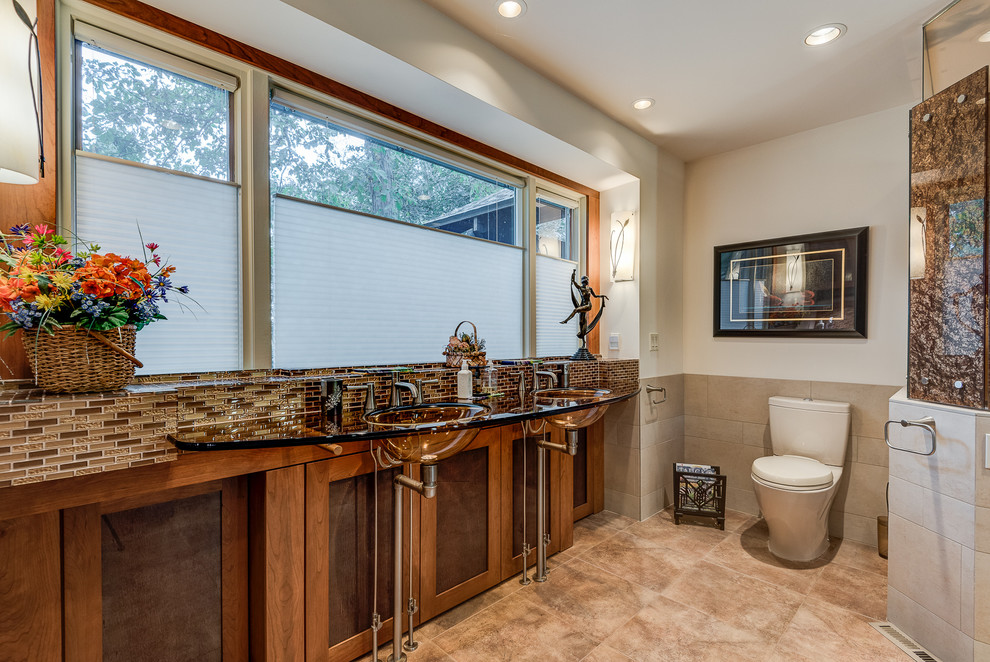 Large trendy master glass tile ceramic tile and brown floor doorless shower photo in Chicago with glass-front cabinets, medium tone wood cabinets, an integrated sink, glass countertops, a one-piece toilet and white walls