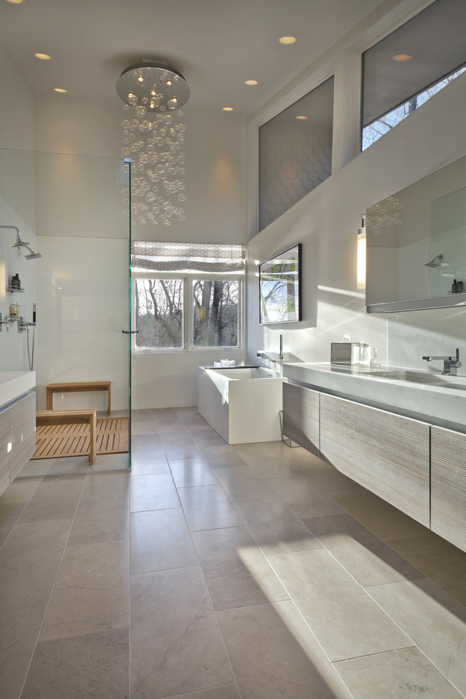 Modelo de cuarto de baño contemporáneo con armarios con paneles lisos, puertas de armario de madera clara, ducha a ras de suelo y paredes blancas