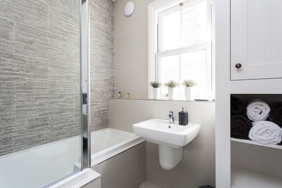 Inspiration for a small contemporary shower room bathroom in Other with a wall-mounted sink, shaker cabinets, white cabinets, an alcove bath, a shower/bath combination, grey tiles, porcelain tiles and porcelain flooring.