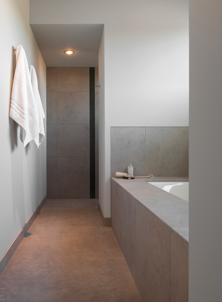 Design ideas for a contemporary bathroom in Santa Barbara with a submerged bath, grey walls and grey floors.