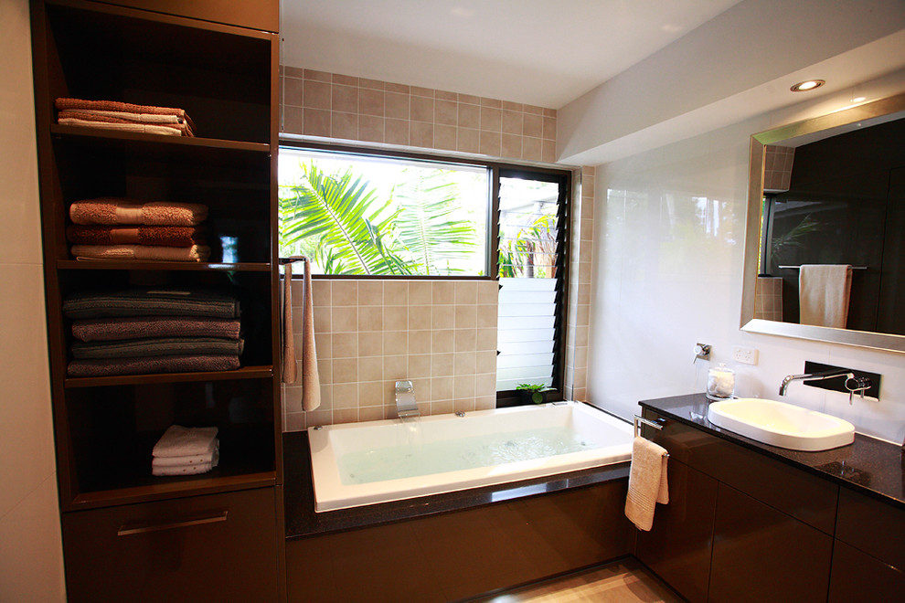 Medium sized modern bathroom in Brisbane with a built-in bath, beige tiles, travertine flooring and beige floors.