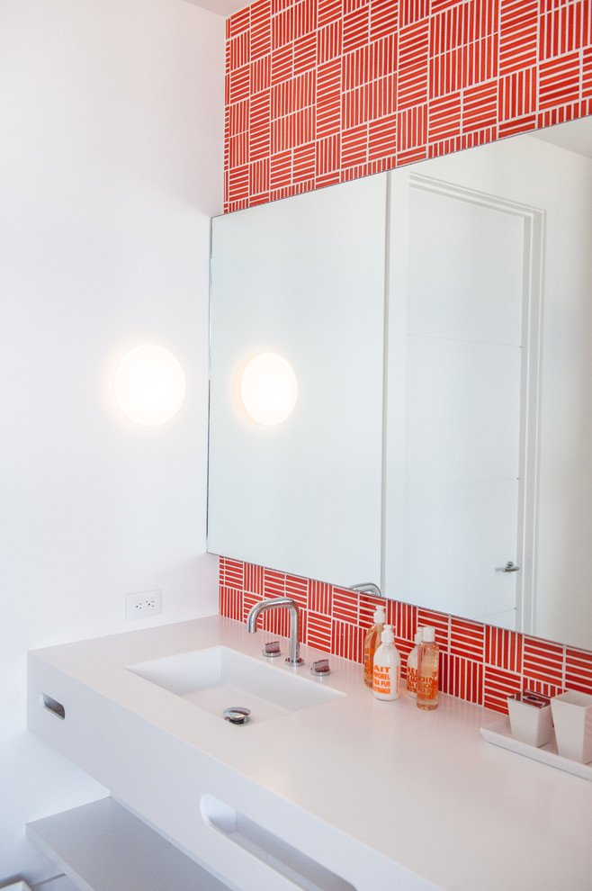 This is an example of a contemporary bathroom in Boston with open cabinets, multi-coloured tiles, red tiles, white walls and an integrated sink.