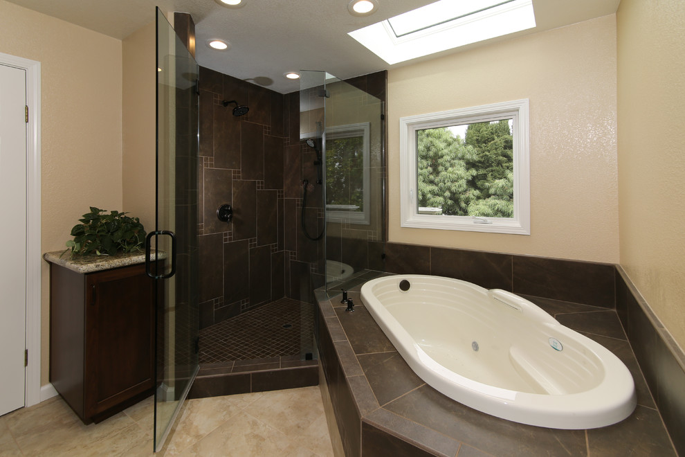 Example of a mid-sized trendy master black tile and porcelain tile travertine floor and beige floor bathroom design in San Francisco with beige walls, a hinged shower door, recessed-panel cabinets, dark wood cabinets, granite countertops and beige countertops