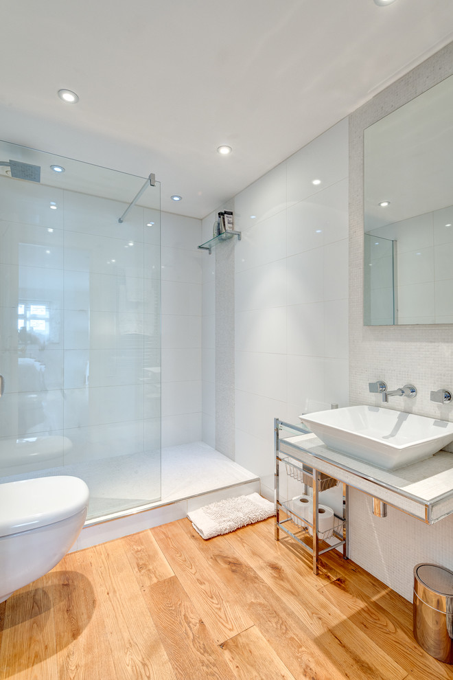 This is an example of a contemporary bathroom in Other with a vessel sink and glass tiles.