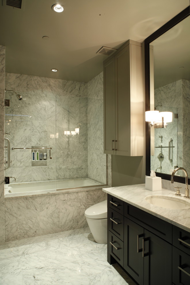 Trendy marble tile bathroom photo in Austin with marble countertops