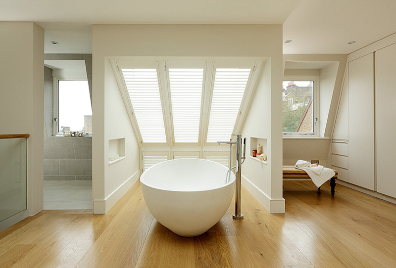 Photo of a contemporary bathroom in London with a vessel sink, flat-panel cabinets, a freestanding bath, an alcove shower and white walls.
