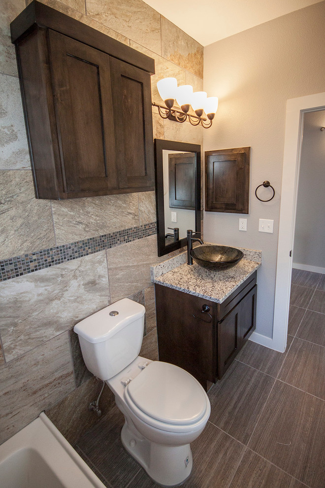 Bathroom - small contemporary 3/4 beige tile and ceramic tile ceramic tile bathroom idea in Austin with a vessel sink, shaker cabinets, medium tone wood cabinets, granite countertops, a two-piece toilet and gray walls