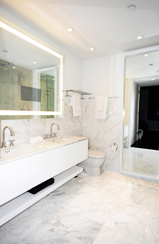 Example of a trendy white tile bathroom design in New York with an undermount sink, flat-panel cabinets and white cabinets