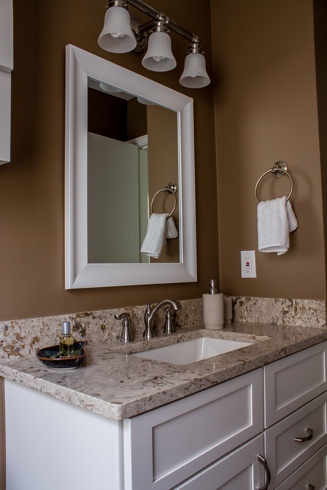 Small trendy master beige tile and stone tile alcove shower photo in Detroit with an undermount sink, shaker cabinets, white cabinets, quartz countertops, a two-piece toilet and beige walls