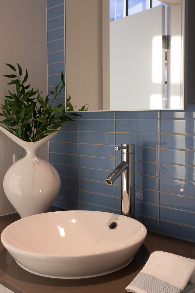 Inspiration for a contemporary bathroom remodel in Vancouver with solid surface countertops and a drop-in sink
