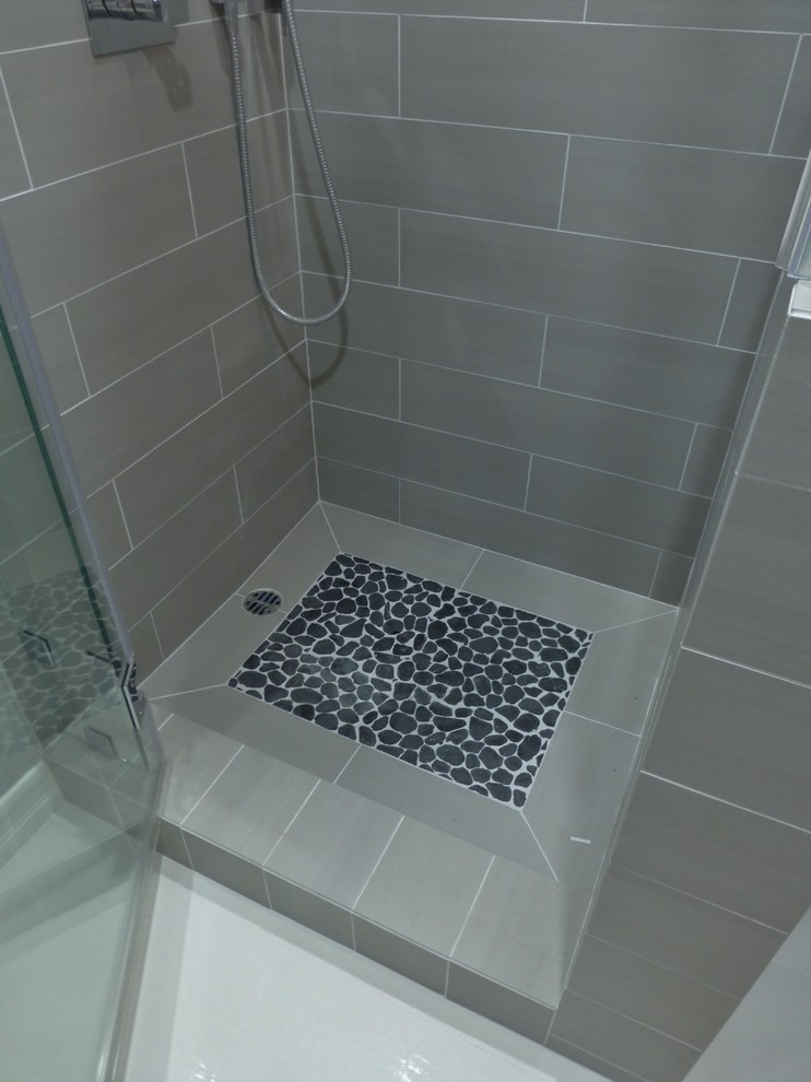 Corner shower - small contemporary 3/4 gray tile and porcelain tile porcelain tile corner shower idea in Los Angeles with an undermount sink, recessed-panel cabinets, dark wood cabinets, quartz countertops, a one-piece toilet and gray walls