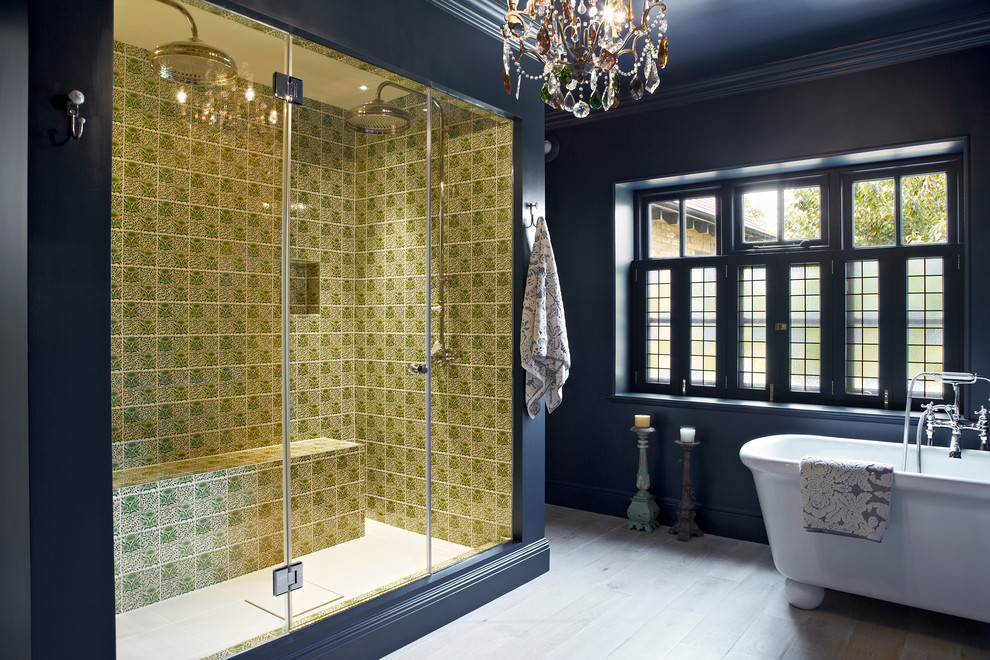 Inspiration for a contemporary bathroom in London with a freestanding bath, a double shower, multi-coloured tiles, blue walls and light hardwood flooring.