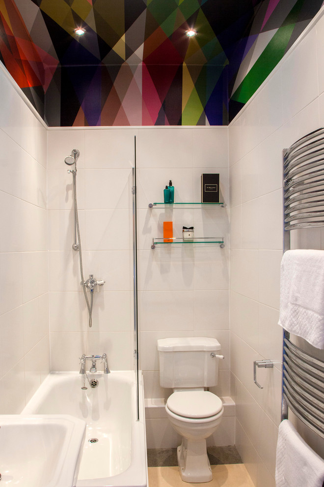 Contemporary bathroom in Other with a shower/bath combination, a two-piece toilet, white tiles and an alcove bath.