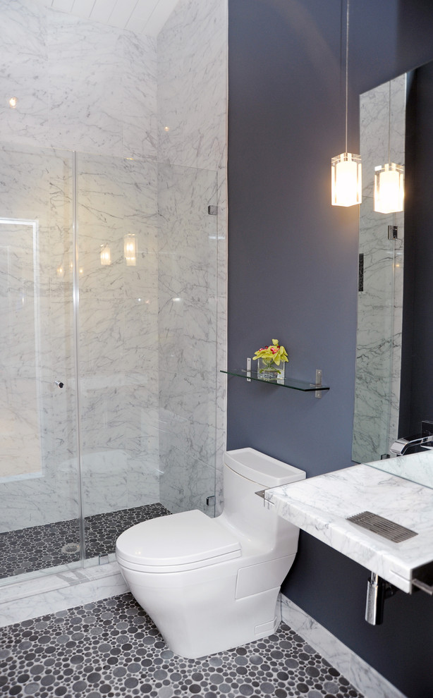 This is an example of a medium sized contemporary shower room bathroom in Philadelphia with a wall-mounted sink, marble worktops, an alcove shower, a one-piece toilet, blue tiles, stone tiles, blue walls and mosaic tile flooring.