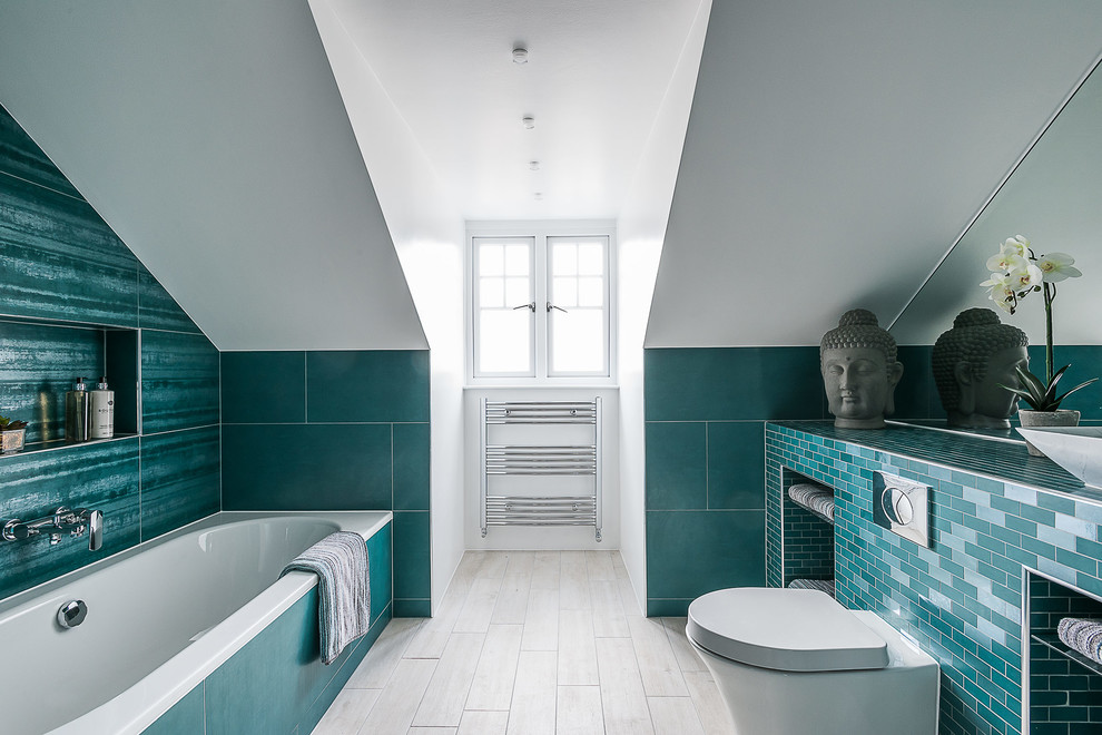 This is an example of a traditional ensuite bathroom in London with open cabinets, a built-in bath, a wall mounted toilet, white walls and a submerged sink.