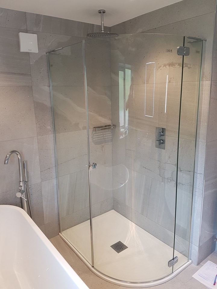 Medium sized contemporary family bathroom in Other with a freestanding bath, a corner shower, grey tiles, porcelain tiles, a wall-mounted sink, marble worktops, a wall mounted toilet, grey walls and porcelain flooring.