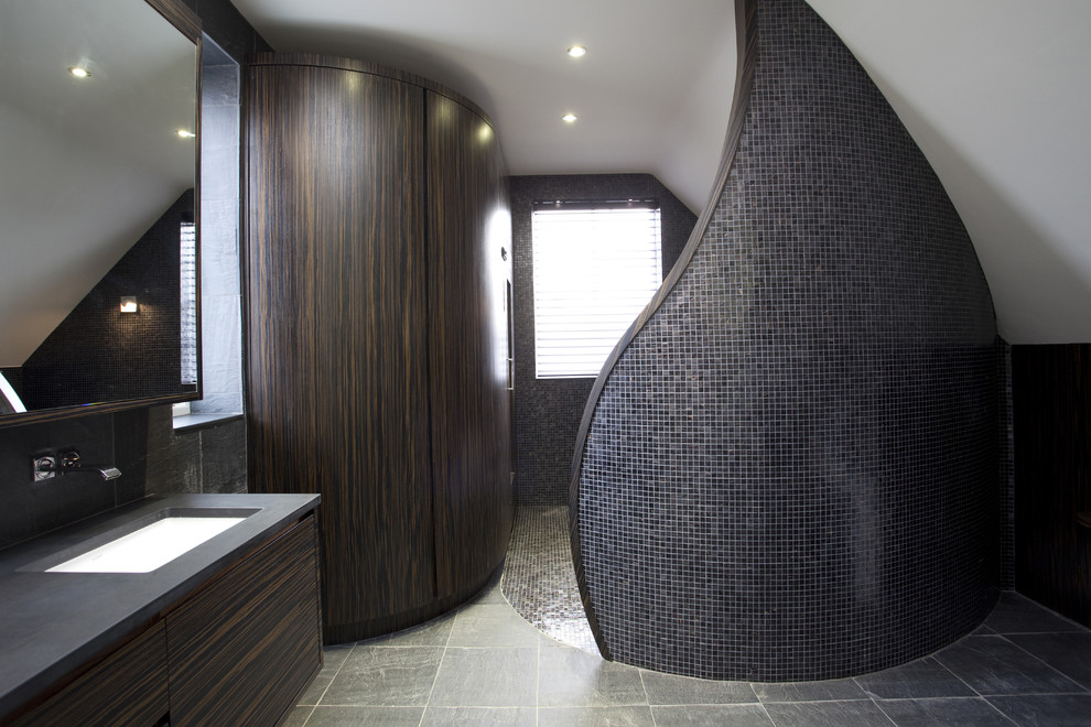 Contemporary bathroom in London with a freestanding bath and mosaic tiles.