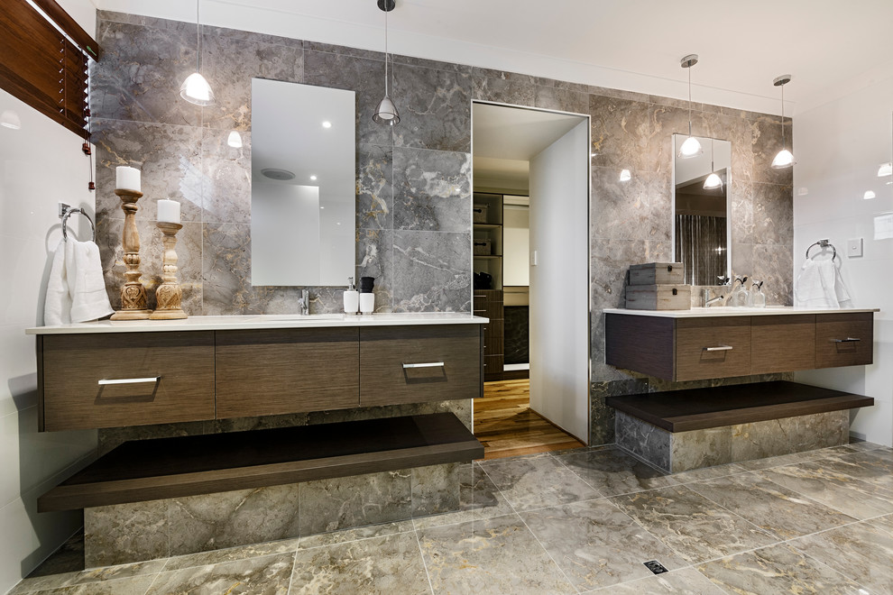 Идея дизайна: ванная комната в современном стиле с плоскими фасадами, темными деревянными фасадами и серой плиткой