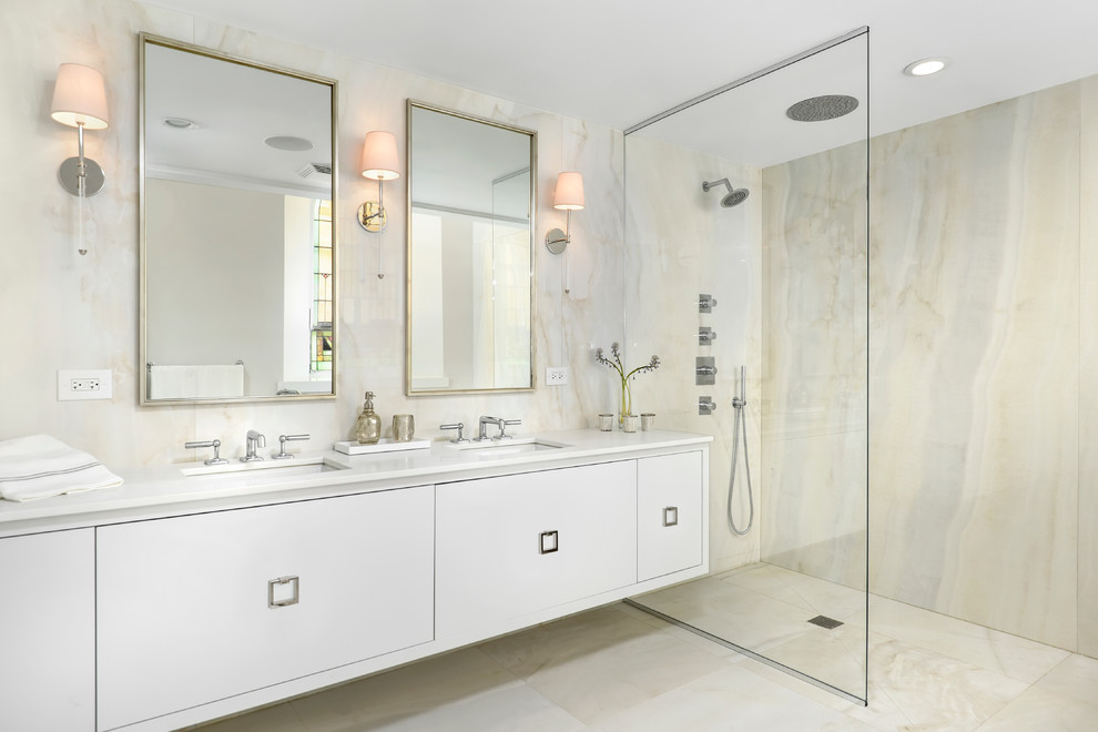 Bathroom - contemporary beige tile and stone slab beige floor bathroom idea in Chicago with an undermount sink, flat-panel cabinets and white cabinets