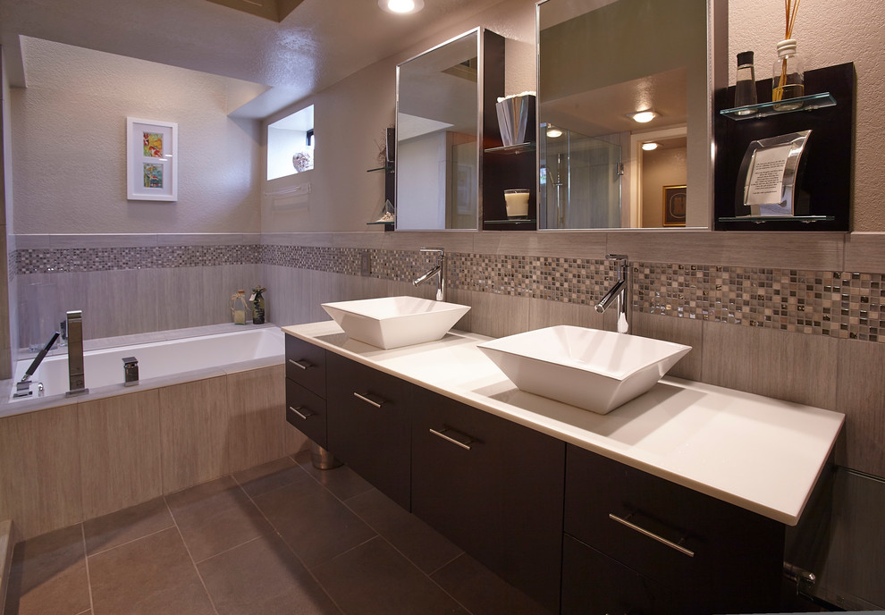This is an example of a medium sized contemporary ensuite bathroom in San Diego with flat-panel cabinets, dark wood cabinets, a submerged bath, grey tiles, porcelain tiles, grey walls, porcelain flooring, a vessel sink, engineered stone worktops, a corner shower, grey floors and a hinged door.