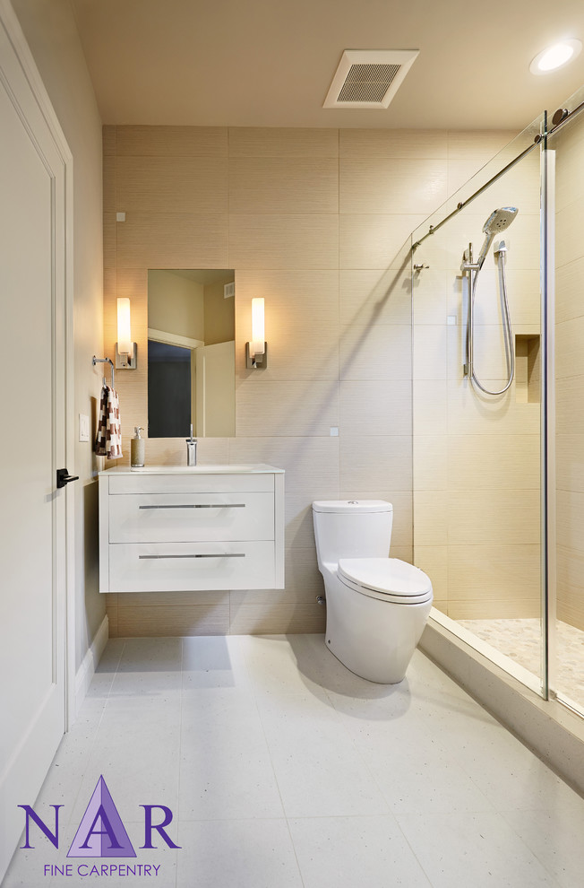 Photo of a small contemporary bathroom in Other with an integrated sink, flat-panel cabinets, white cabinets, an alcove shower, a one-piece toilet, beige tiles, porcelain tiles, grey walls and porcelain flooring.
