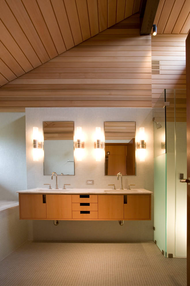 Imagen de cuarto de baño contemporáneo con armarios con paneles lisos, puertas de armario de madera oscura, ducha esquinera, baldosas y/o azulejos blancos y suelo con mosaicos de baldosas