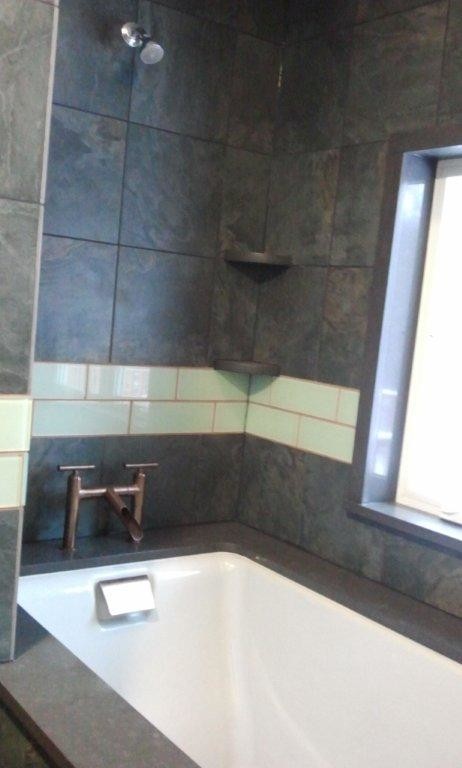 Inspiration för ett litet funkis en-suite badrum, med ett fristående handfat, släta luckor, gröna skåp, bänkskiva i kvarts, ett undermonterat badkar, en dusch/badkar-kombination, grön kakel, keramikplattor och klinkergolv i keramik