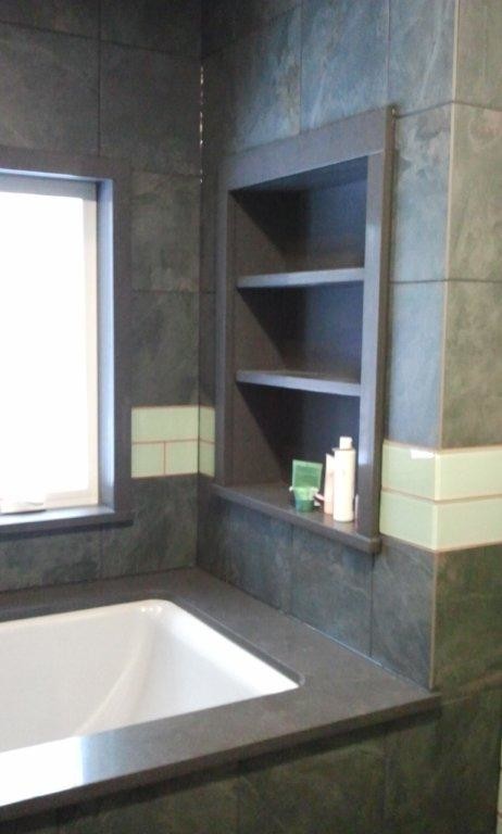 Inspiration for a small contemporary ensuite bathroom in New York with a vessel sink, flat-panel cabinets, green cabinets, engineered stone worktops, a submerged bath, a shower/bath combination, green tiles, ceramic tiles and ceramic flooring.