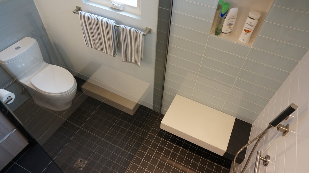 Inspiration for a small contemporary master gray tile and glass tile porcelain tile and black floor doorless shower remodel in Phoenix with flat-panel cabinets, light wood cabinets, a one-piece toilet, gray walls, an undermount sink, quartz countertops and a hinged shower door