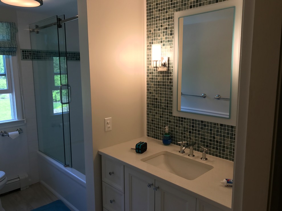 Inspiration for a mid-sized contemporary 3/4 blue tile, green tile and mosaic tile light wood floor and beige floor bathroom remodel in Providence with recessed-panel cabinets, white cabinets, a two-piece toilet, white walls, an undermount sink and solid surface countertops
