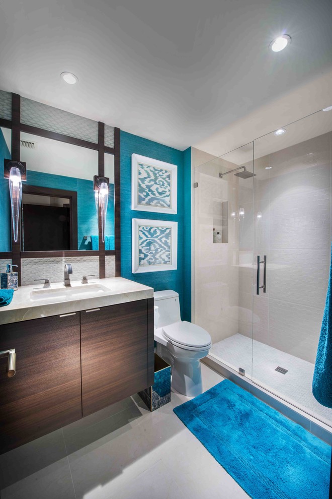 Inspiration for a contemporary beige tile ceramic tile alcove shower remodel in Miami with an undermount sink, flat-panel cabinets, dark wood cabinets, a two-piece toilet and blue walls