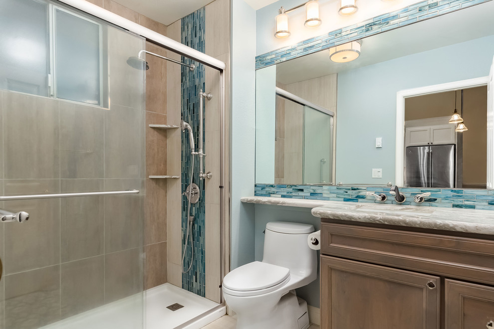 На фото: ванная комната среднего размера в современном стиле с коричневыми фасадами, синей плиткой, душевой кабиной и душем с раздвижными дверями