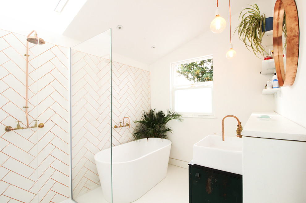Small contemporary family bathroom in London with freestanding cabinets, green cabinets, a freestanding bath, a walk-in shower, a wall mounted toilet, white tiles, metro tiles, white walls, vinyl flooring, a console sink, wooden worktops, white floors and an open shower.