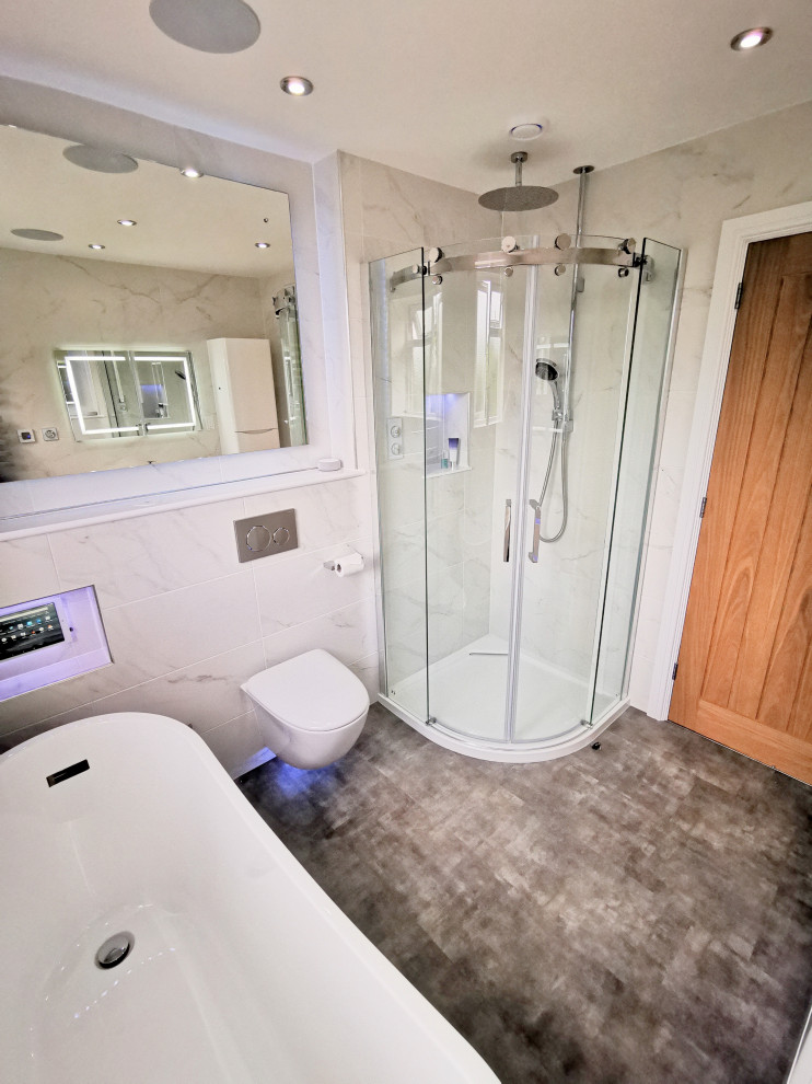 Medium sized contemporary family bathroom in West Midlands with flat-panel cabinets, white cabinets, a freestanding bath, a corner shower, a wall mounted toilet, black and white tiles, marble tiles, white walls, vinyl flooring, a wall-mounted sink, grey floors, a sliding door, white worktops, a wall niche, a single sink and a floating vanity unit.