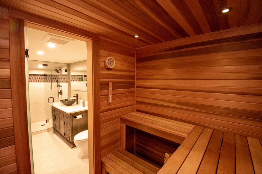Inspiration pour un très grand sauna design en bois brun avec un placard à porte shaker, une baignoire posée, une douche d'angle, WC séparés, un carrelage multicolore, des carreaux de céramique, un mur vert, un sol en carrelage de céramique, une vasque, un plan de toilette en granite, un sol beige, une cabine de douche à porte battante et un plan de toilette blanc.