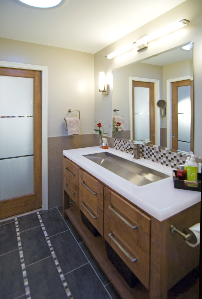 This is an example of a contemporary bathroom in DC Metro with medium wood cabinets.
