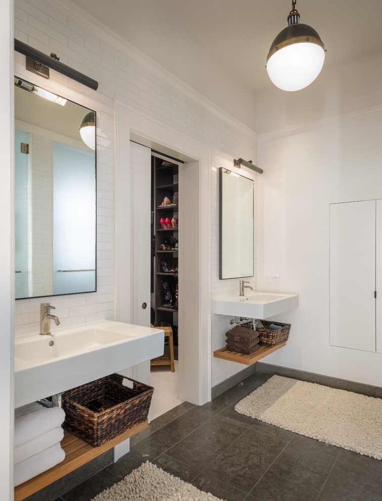 Photo of a contemporary bathroom in San Francisco with a wall-mounted sink and feature lighting.
