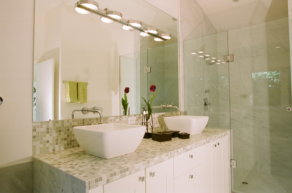 Imagen de cuarto de baño actual con baldosas y/o azulejos en mosaico, lavabo sobreencimera y encimera de azulejos