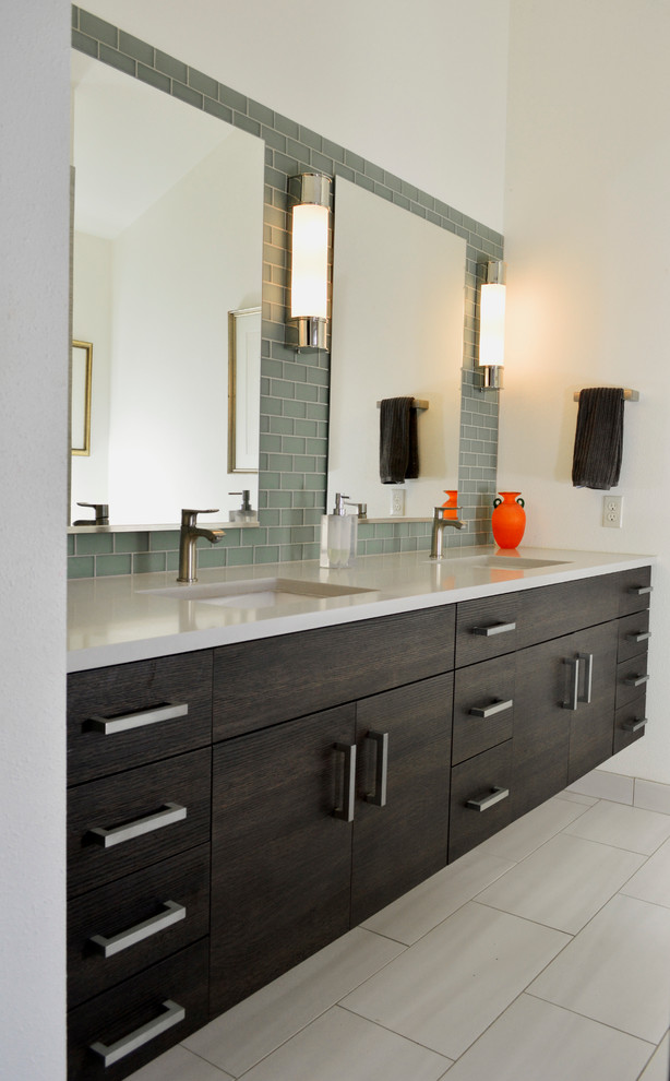 Design ideas for a medium sized contemporary ensuite bathroom in Seattle with flat-panel cabinets, dark wood cabinets, a built-in bath, a shower/bath combination, green tiles, glass tiles, white walls, porcelain flooring, a submerged sink, engineered stone worktops and white floors.