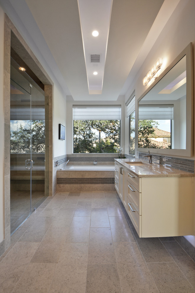 This is an example of a contemporary bathroom in Austin with a submerged sink, shaker cabinets, beige cabinets, a submerged bath, an alcove shower and white walls.